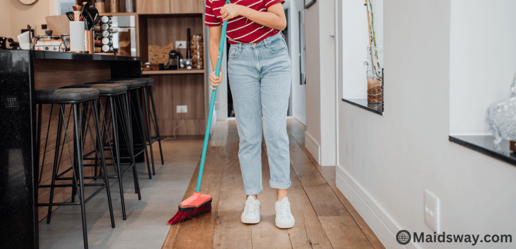 How Often Should You Sweep Your Floors for a Clean Home? 3 sweeping the floor